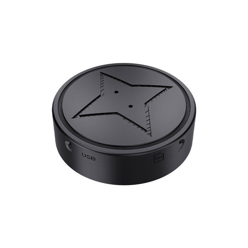 Black mini GPS tracker with strong magnet, top view showing star emblem and USB label