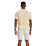 Cream knitted polo shirt, back view, ribbed knit texture and short sleeves