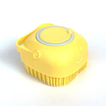 Yellow silicone pet bath massage brush with short bristles and gray inset ring