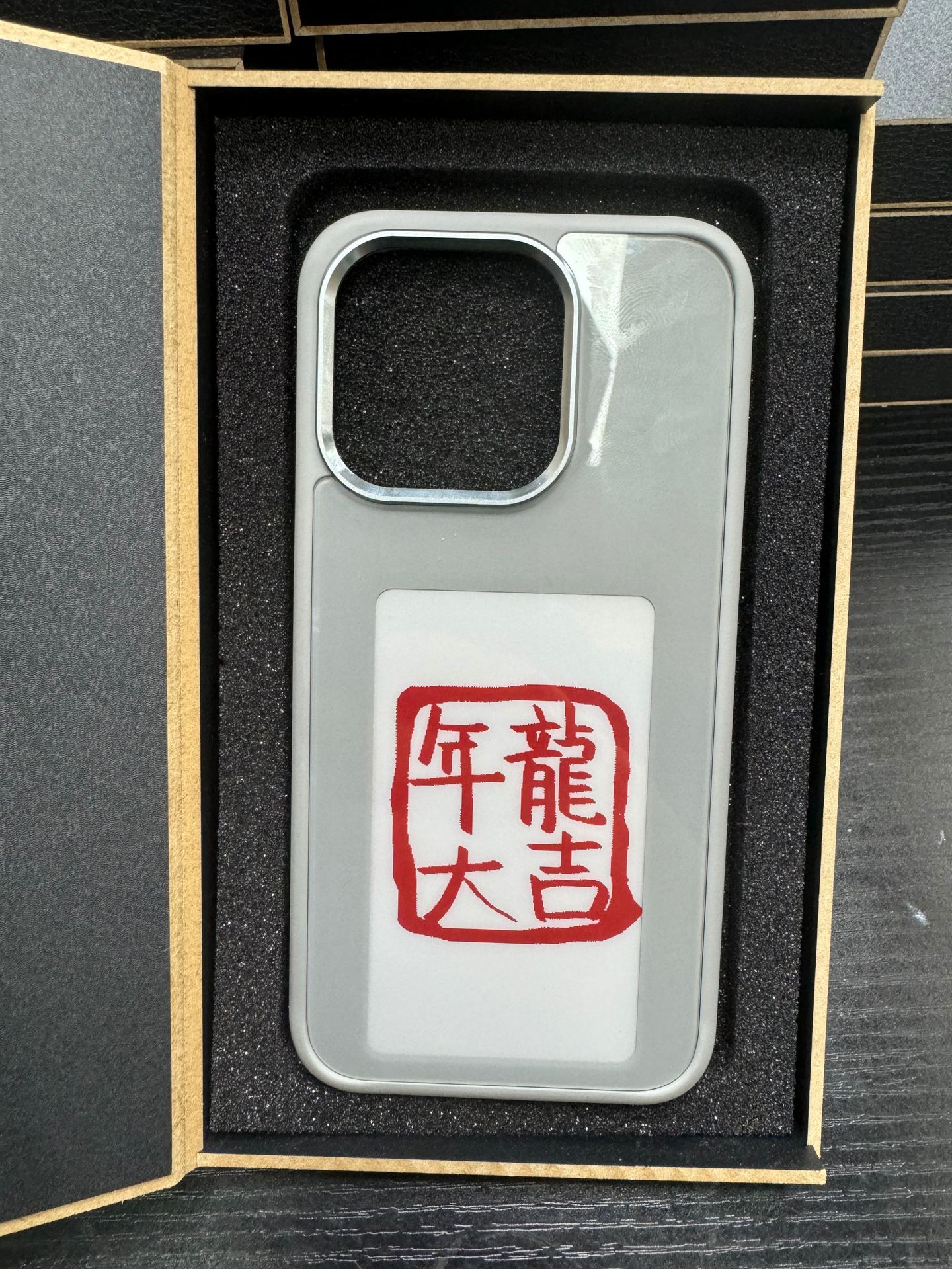 Light gray NFC smart display phone case with red seal graphic in display window
