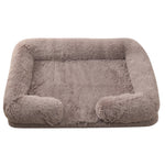 Taupe plush dog bed with padded sides and rounded bolster base