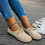 Beige suede round-toe flat lace-up shoes with knotted bow at front