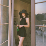 One-piece modest swimsuit with high neck, sleeveless design, flared skirt peplum, dark