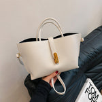 White textured PU bucket tote bag with front zipper and two top handles.