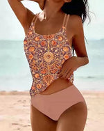 High-waist bikini swimsuit with purple-orange patterned tank top and nude solid bottoms