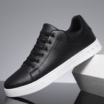 Black lace-up casual shoes with round toe, textured white sole, and cushioned collar
