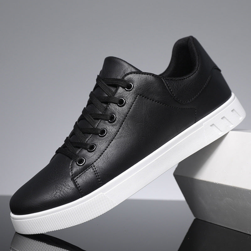 Black lace-up casual shoes with round toe, textured white sole, and cushioned collar