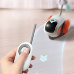 Remote control cat car toy with white body, black nose, and orange side wheel