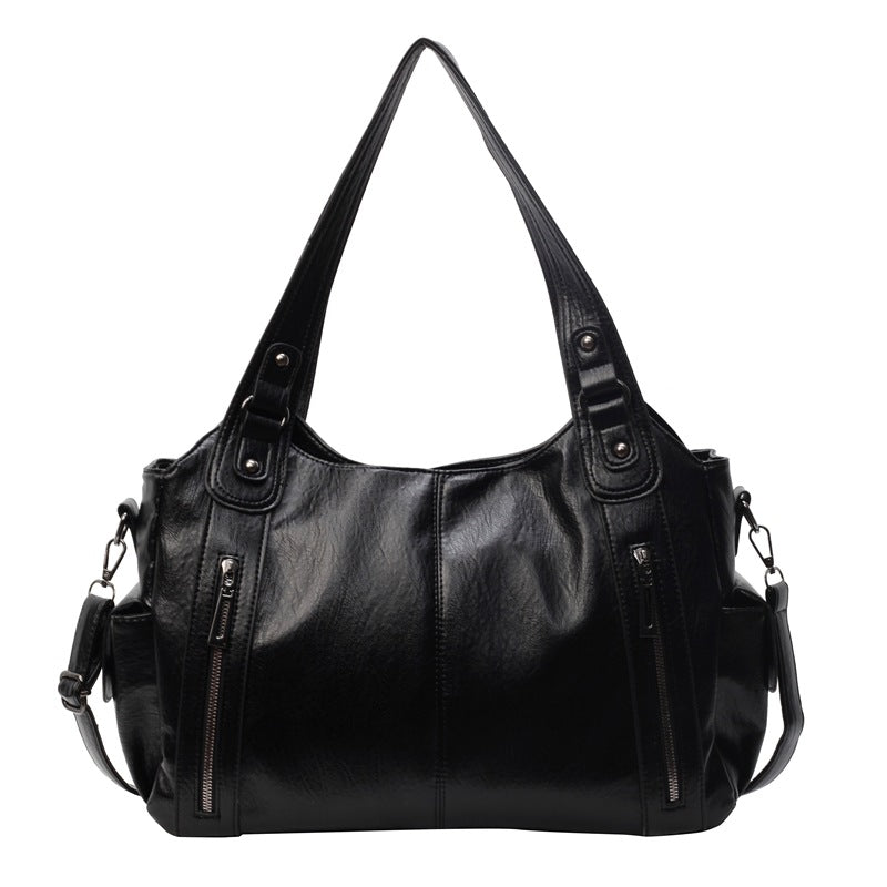 Women’s retro PU handbag with top handles, black, two front zip pockets and side straps.