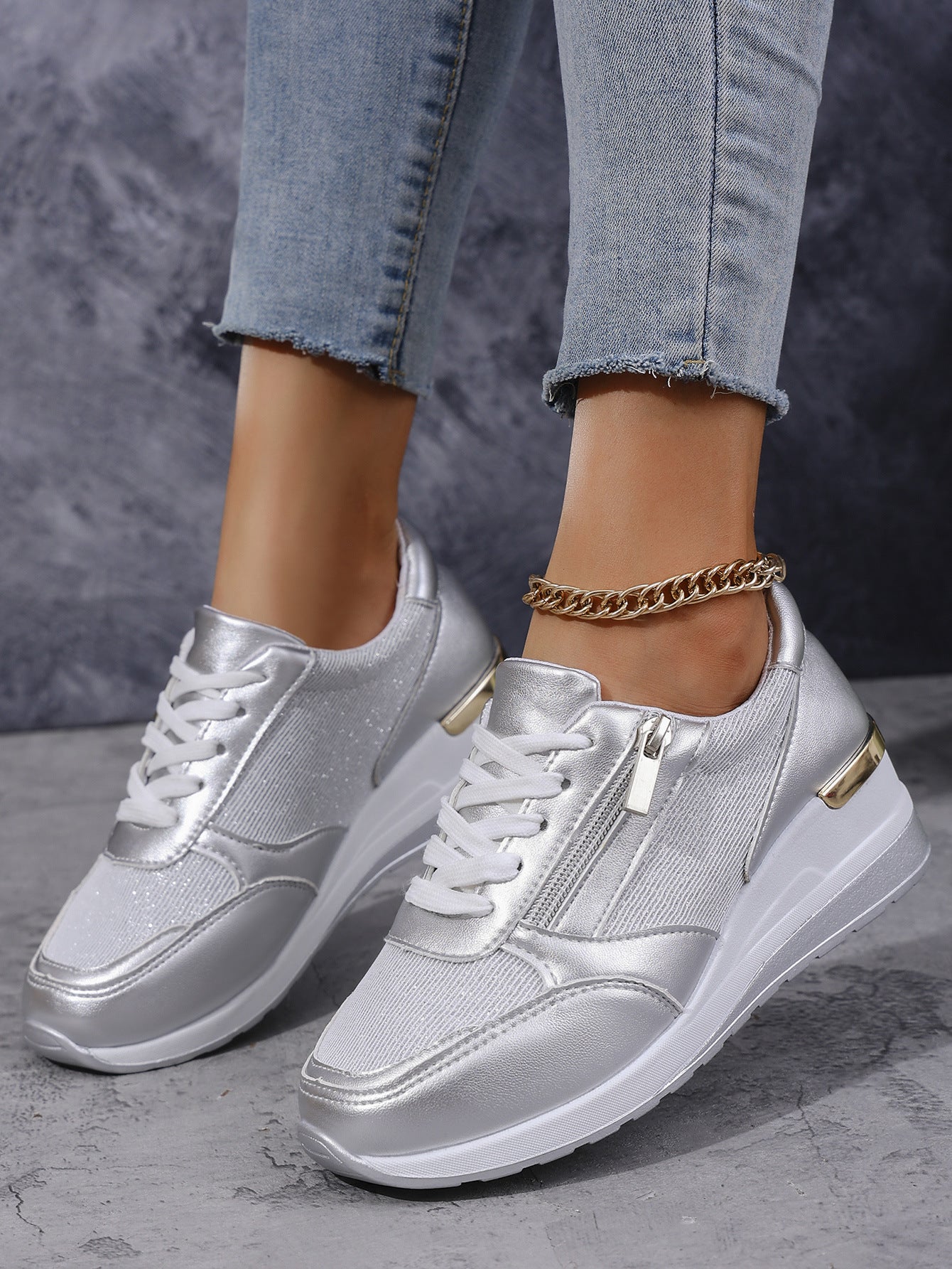 Women's silver lace-up sneakers with side zip, thick white sole and ankle chain detail
