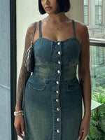 Denim suspender dress with square neckline, front buttons, and curved chest pockets