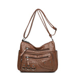 Brown PU leather crossbody bag with front zip compartments, braided pocket, and 3 rings