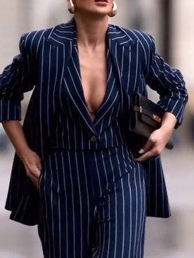 Navy pinstripe blazer with deep V neckline and button front over wide-leg pants