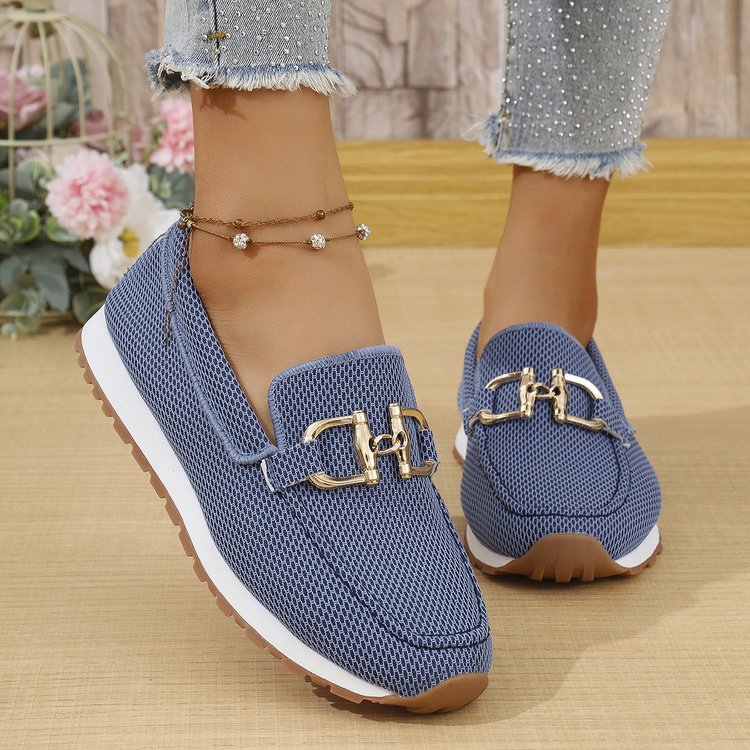 Blue women’s canvas flat sneakers with gold horsebit-style detail and white outsole.