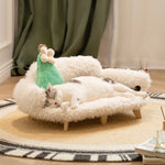 Luxury wooden pet bed with fluffy white cover, cat lying down with green toy pillow