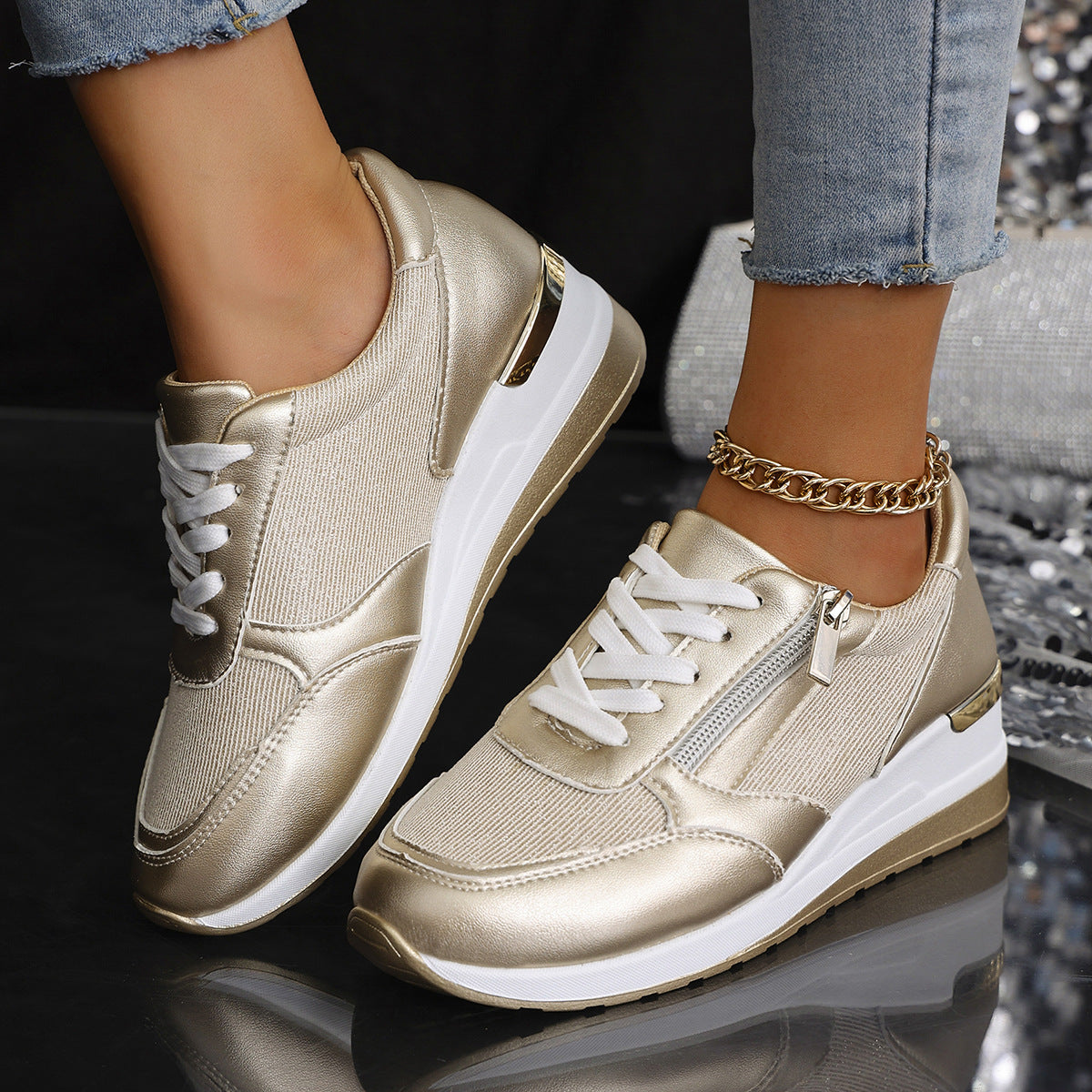 Women's gold lace-up sneakers with side zip, thick white sole and ankle chain detail