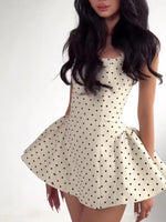White polka dot mini dress with structured seams and gathered flared skirt