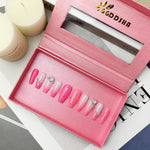 Open pink press-on acrylic nail box showing short mixed pink and white false nails