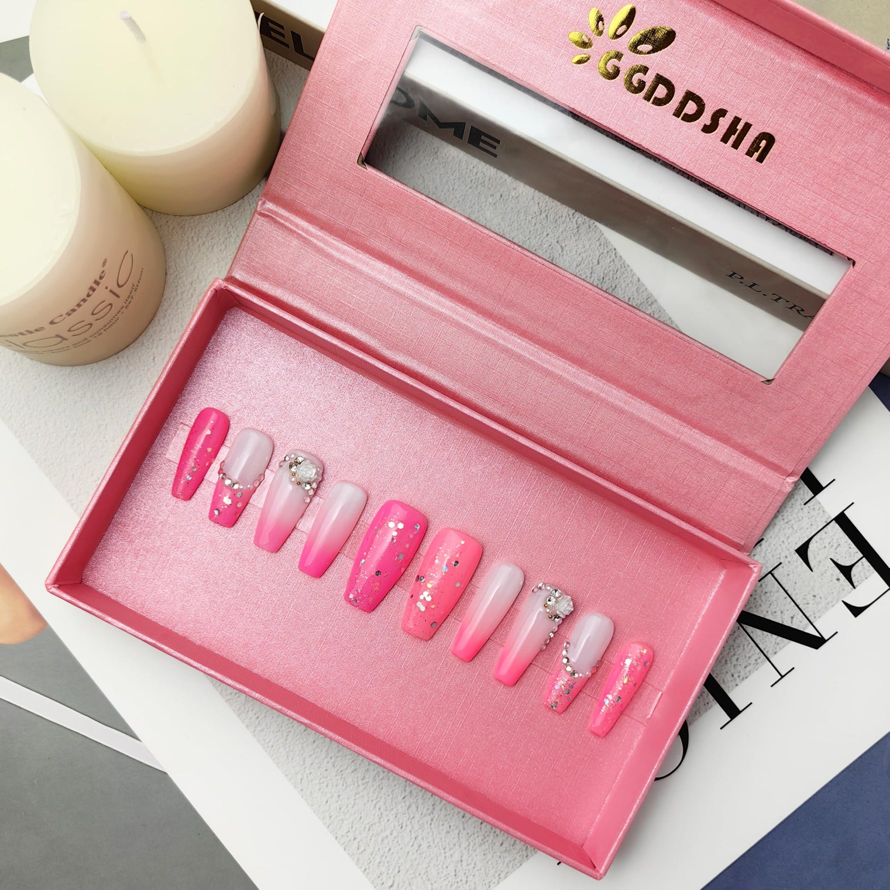 Open pink press-on acrylic nail box showing short mixed pink and white false nails