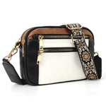 Black and white colorblock crossbody bag with triple zip front and floral embroidered strap