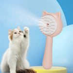 Pink self-cleaning pet mist grooming brush with cat-shaped head and raised bristles