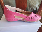Magenta pink round-toe wedge sandals with laser-cut upper and side stitching