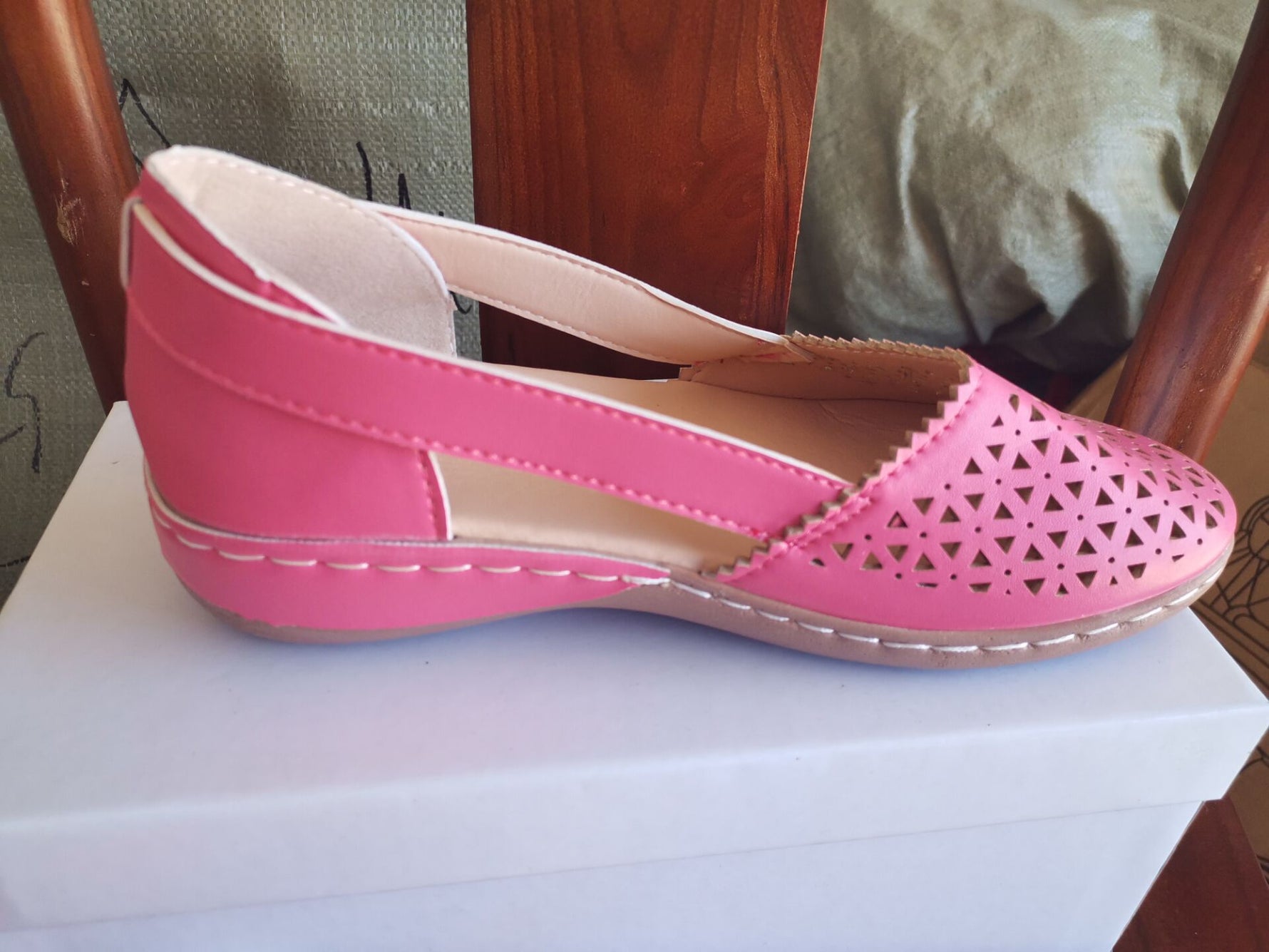 Magenta pink round-toe wedge sandals with laser-cut upper and side stitching