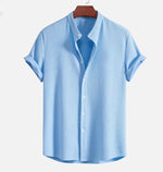 Light blue short sleeve button-up shirt with pointed collar and central button placket
