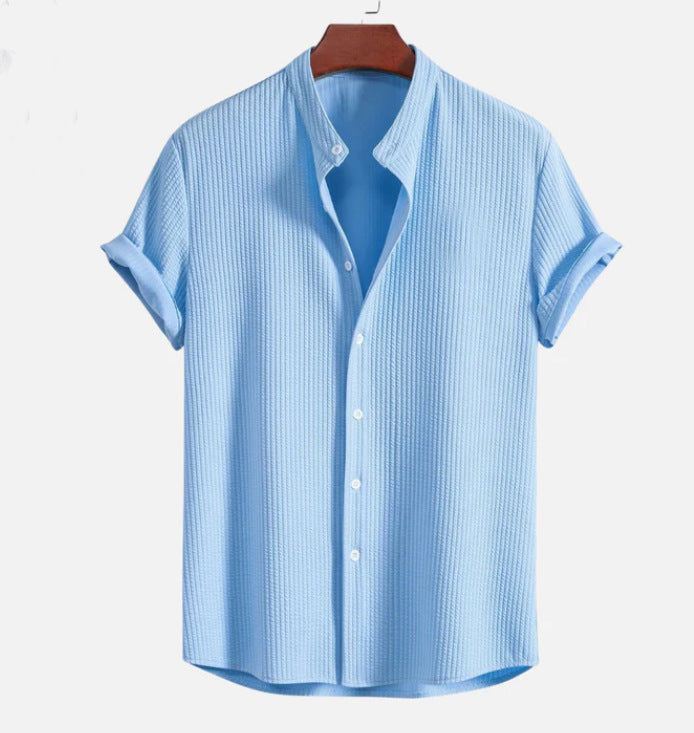 Light blue short sleeve button-up shirt with pointed collar and central button placket
