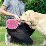 Pink silicone dog treat pouch on waist during dog training
