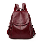 Women's PU leather travel backpack with front flap and side zippers, burgundy