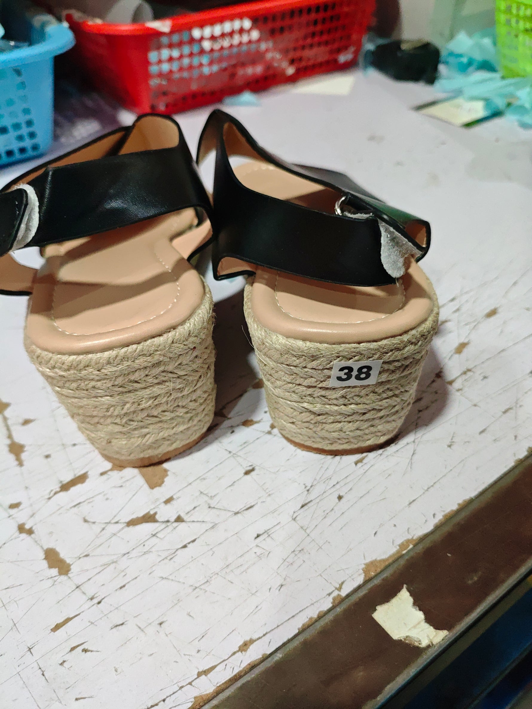 Open-toe wedge sandals with crisscross straps, black PU and tan espadrille platform, rear view