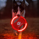 LED dog flying disc, red fabric with paw print, bright white glowing ring