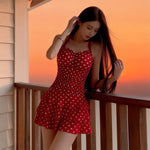Red polka-dot one-piece skirt swimsuit with ruched bust and tiered ruffle hem