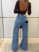 Light blue high-waisted flared jeans with patch pockets at thighs