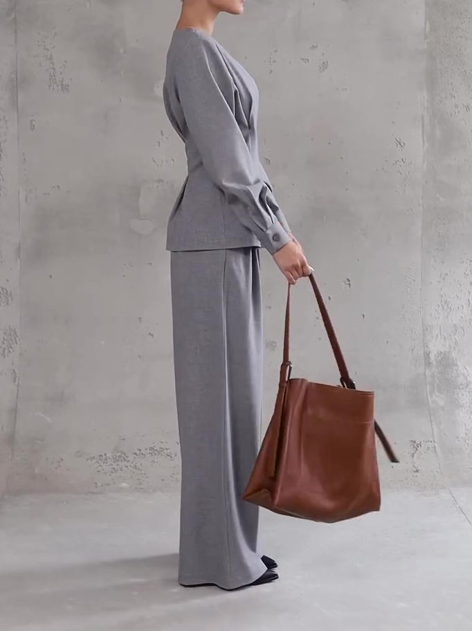 Light gray wide-leg pants and V-neck button top set, side profile with tote