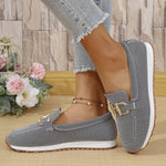 Dark women’s mesh canvas slip-on sneakers with gold horsebit-style detail and white sole.