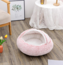 Round pink plush pet bed, open nest with thick padded rim