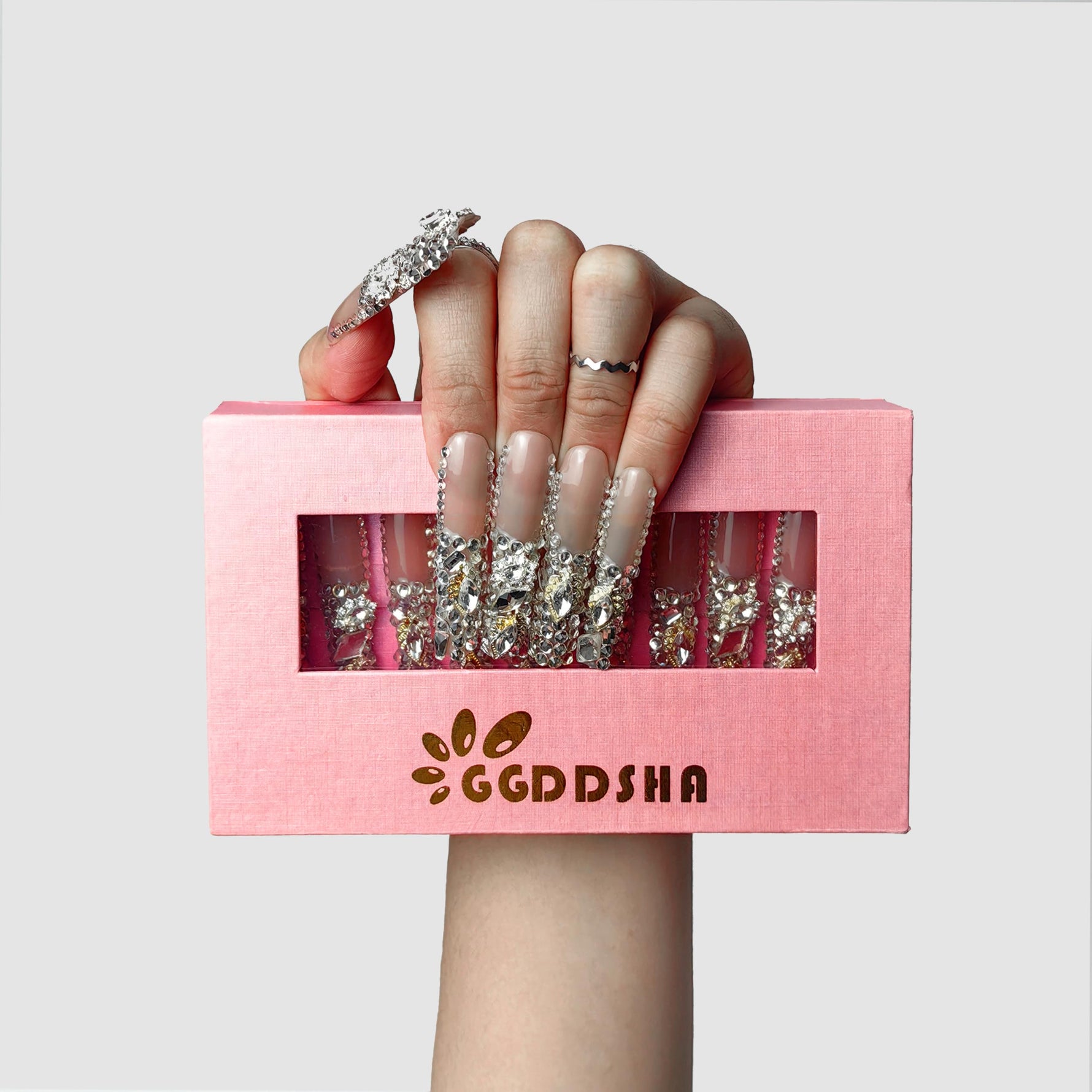 Blush short press-on nails with silver rhinestone and stud detailing, glossy finish