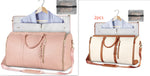Two foldable waterproof duffle bags, pale pink and cream with brown shoulder straps