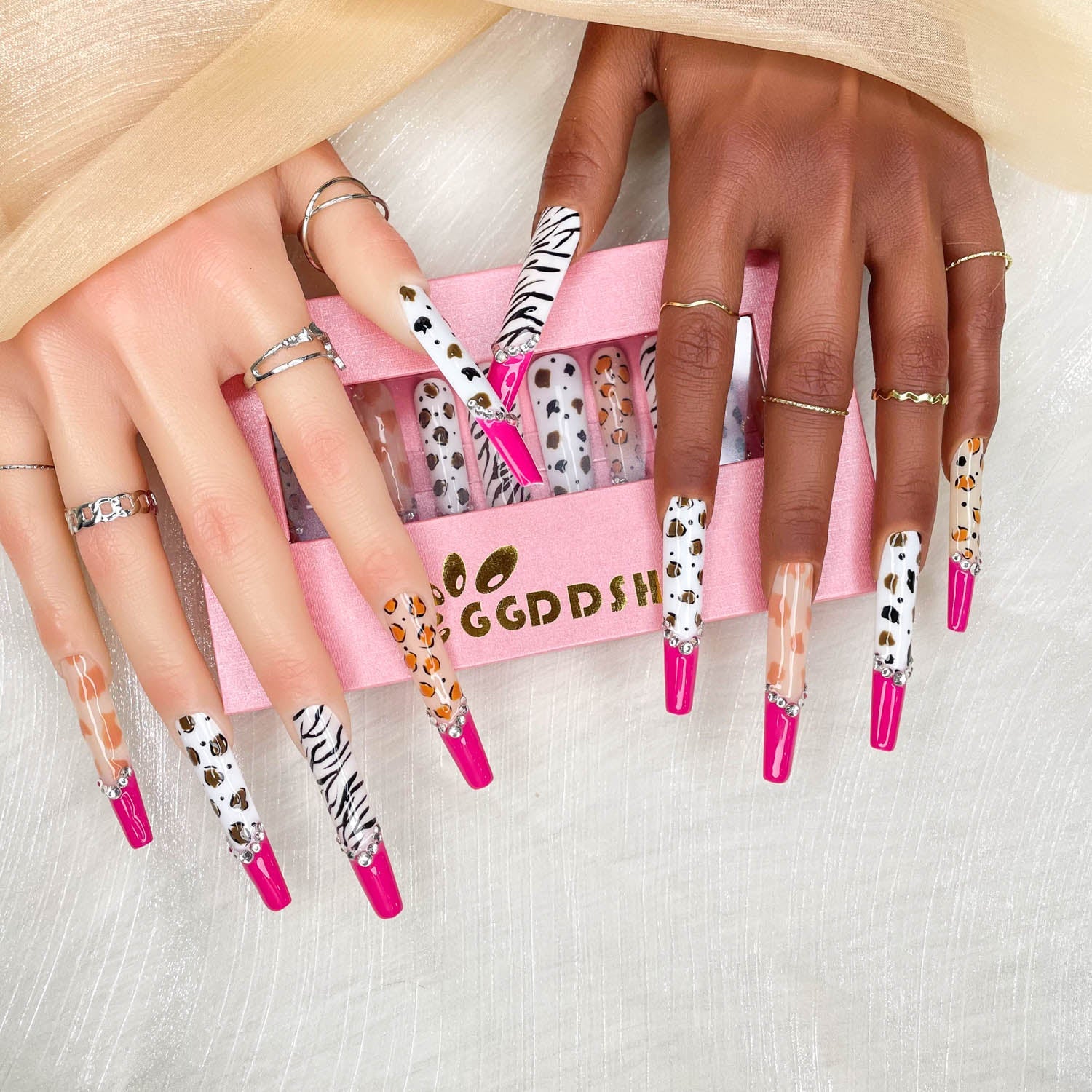 Extra-long stiletto press-on nails with zebra print, leopard dots, and rhinestone accents