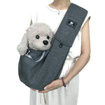 Dark gray pet shoulder carrier sling with plush dog in front pouch