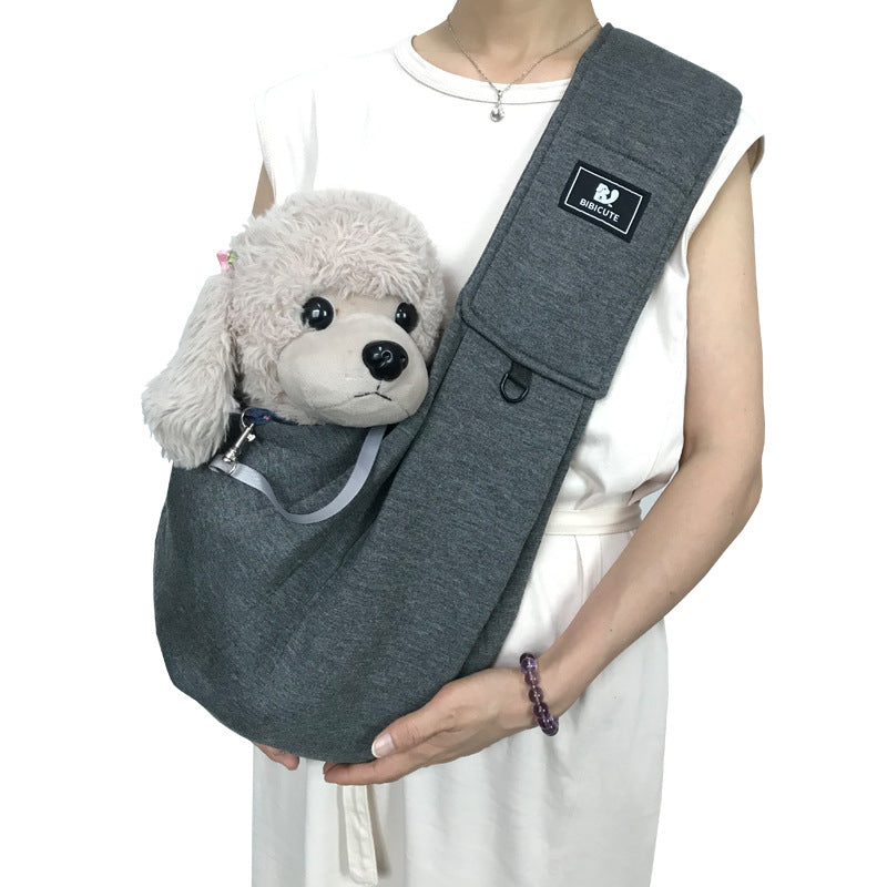 Dark gray pet shoulder carrier sling with plush dog in front pouch