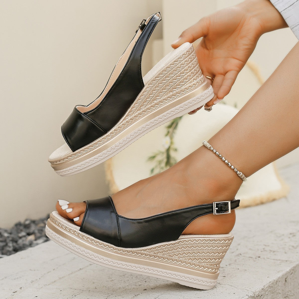 Women’s black wedge platform sandals with open toe, crisscross strap, and buckle closure