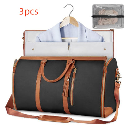 Foldable waterproof travel duffle bag, dark gray/black with orange trim and tassels