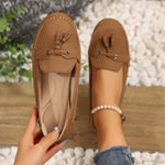 Women’s brown suede loafers with round toe, lace-up tassel detail, flat sole