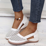 White perforated women's wedge sandals with round toe and cross strap