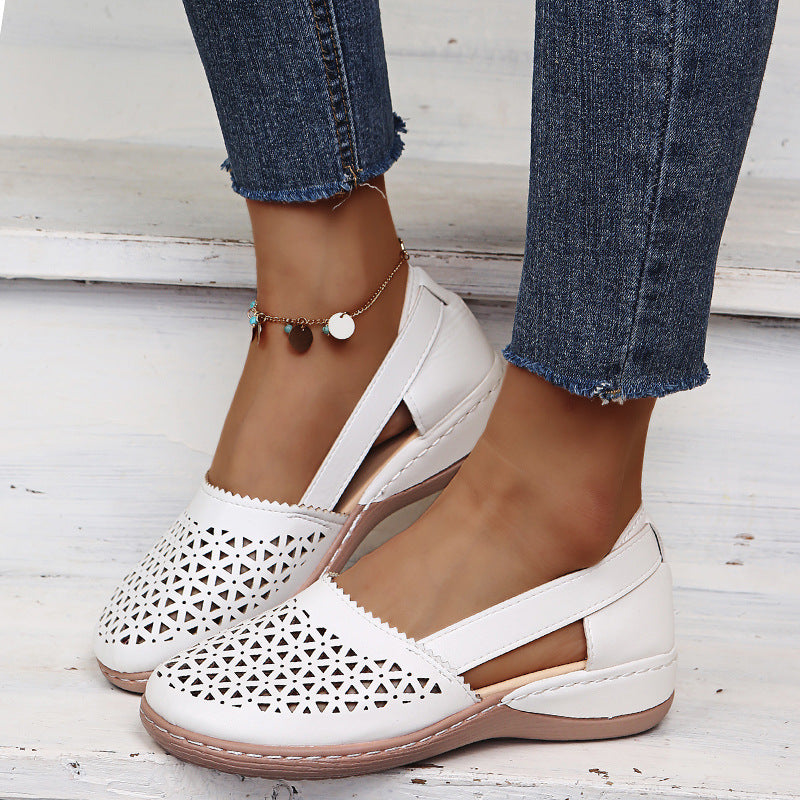 White perforated women's wedge sandals with round toe and cross strap