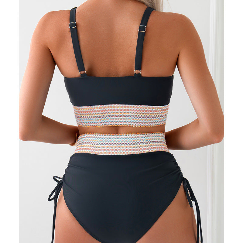 Women’s back view bikini set with dark halter top, multicolor striped waist band, tied bottoms