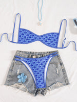 Women’s blue floral bikini set with triangle top and matching high-cut bottoms